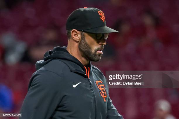 Manager Gabe Kapler of the San Francisco Giants walks across the field in the sixth inning against the Cincinnati Reds at Great American Ball Park on...