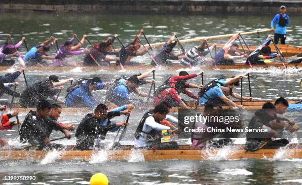 People take part in a dragon boat race ahead of the Dragon Boat Festival on May 27, 2022 in Fuzhou, Fujian Province of China.