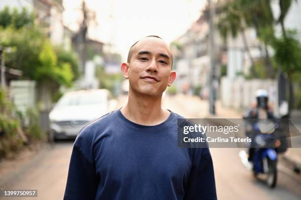 portrait of a handsome thai man on the street - asian guys stock-fotos und bilder