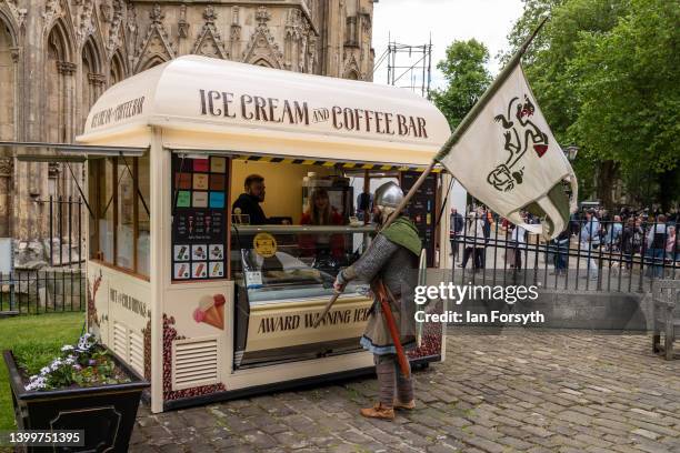 Viking re-enactor stops at an ice cream van before marching through York during the Yorvik Viking Festival on May 28, 2022 in York, England. The...