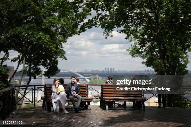 People relax in the Spring sunshine near St. Andrew's Church in Kyiv old town as the city hosts events to celebrate Kyiv Day on the last weekend of...