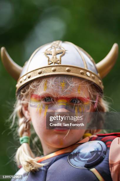 Kara Muse-Young from Evesham sits on her fathers shoulders as Viking re-enactors march through York during the Yorvik Viking Festival on May 28, 2022...
