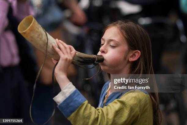 Viking re-enactor blows a horn as they march through York during the Yorvik Viking Festival on May 28, 2022 in York, England. The march through the...