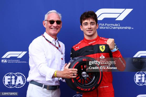 Pole position qualifier Charles Leclerc of Monaco and Ferrari is presented with the Pirelli Pole Position trophy by Liberty CEO Greg Maffei during...