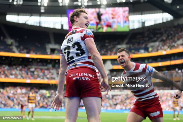 Jai Field of Wigan Warriors celebrates scoring their side's second try during the Betfred Challenge Cup Final match between Huddersfield Giants and...