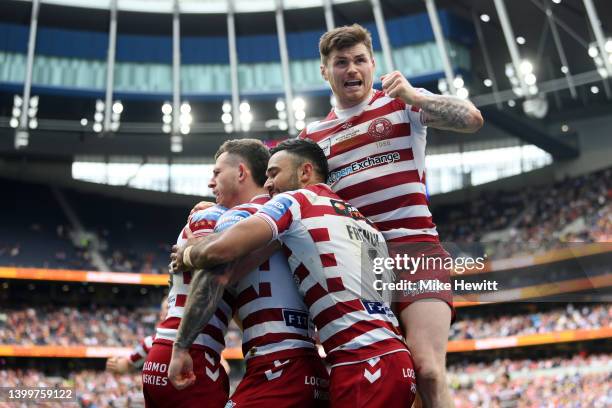 Jai Field of Wigan Warriors celebrates scoring their side's second try with teammates during the Betfred Challenge Cup Final match between...