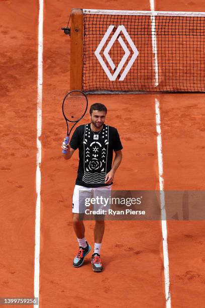 Gilles Simon of France waves to the crowd after losing his final match against Marin Cilic of Croatia during the Men's Singles Third Round match on...