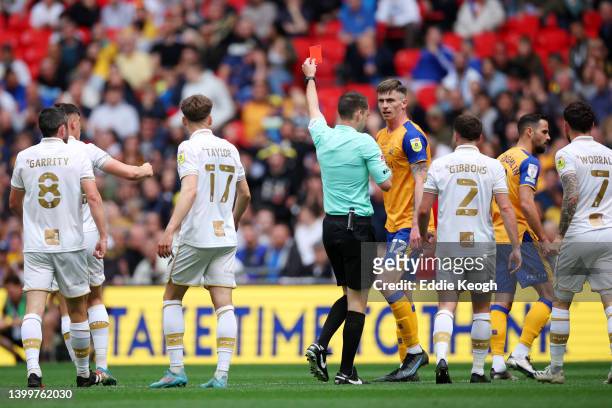 Oliver Hawkins of Mansfield Town is shown a red card from match referee Jarred Gillett during the Sky Bet League Two Play-off Final match between...