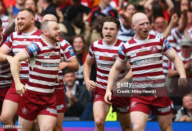 Liam Marshall of Wigan Warriors celebrates scoring their side's third try with teammates during the Betfred Challenge Cup Final match between...