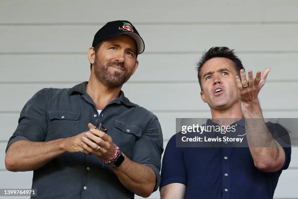 Ryan Reynolds, Owner of Wrexham and Rob McElhenney, Actor and Co-Owner of Wrexham react prior to the Vanarama National League Play-Off Semi Final...