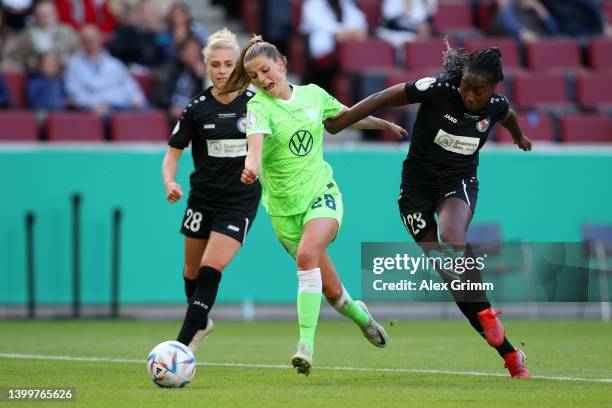 Tabea Wassmuth of VfL Wolfsburg is challenged by Teninsoun Liliane Sissoko of Turbine Potsdam during the Women's DFB Cup final match between VfL...