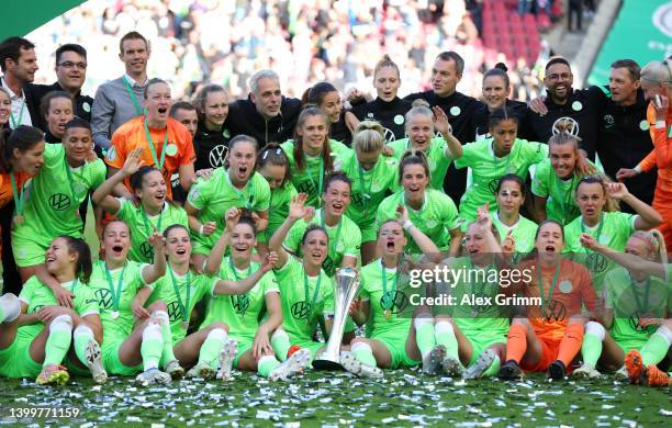 VfL Wolfsburg players celebrate with the DFB-Pokal Frauen trophy after their sides victory during the Women's DFB Cup final match between VfL...