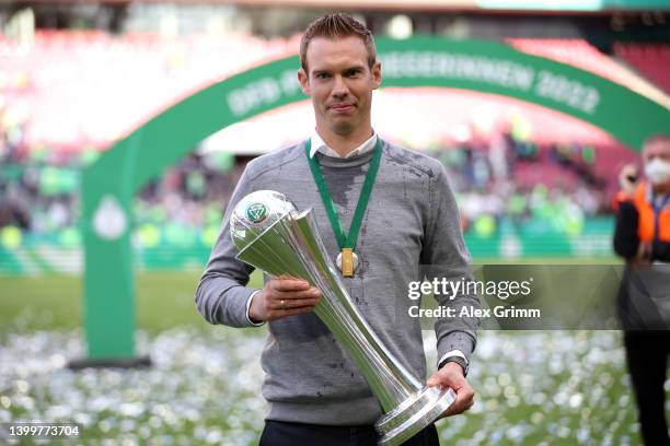 Tommy Stroot, Head Coach of VfL Wolfsburg celebrates with the DFB-Pokal Frauen trophy after their sides victory during the Women's DFB Cup final...