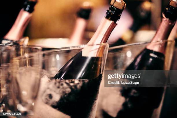 champagne  bottles cooling in ice buckets - champagne cork stock pictures, royalty-free photos & images