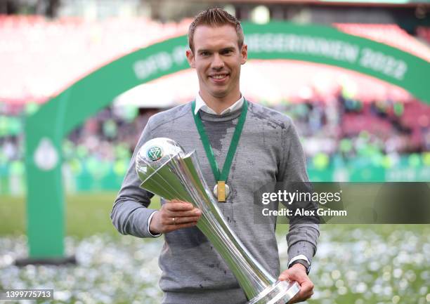 Tommy Stroot, Head Coach of VfL Wolfsburg celebrates with the DFB-Pokal Frauen trophy after their sides victory during the Women's DFB Cup final...