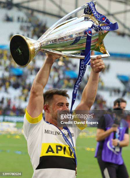Arthur Retiere of La Rochelle lifts the Heineken Champions Cup as their side celebrate after the final whistle following victory in the Heineken...