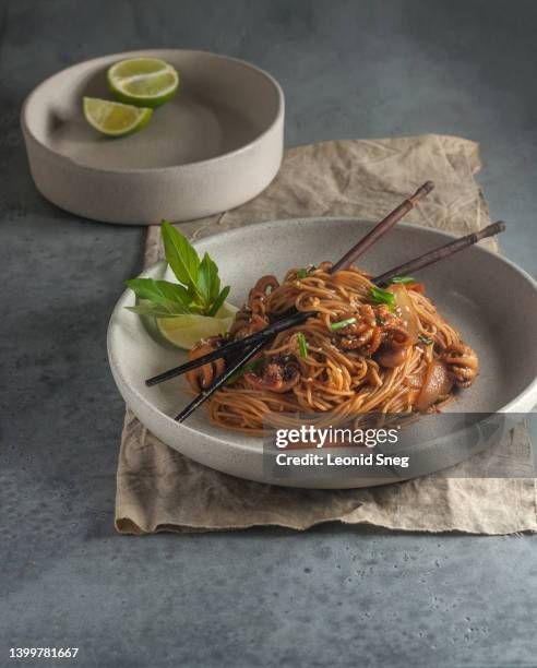 asian noodles with baby octopus on gray background - meal kit stock pictures, royalty-free photos & images