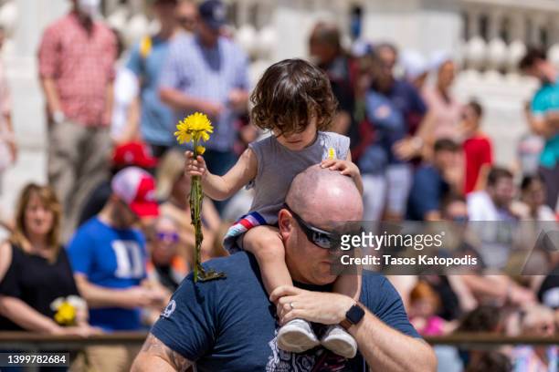 Brent Grooms, US Air Force of Kansas City, Missouri; holds his daughter Elvira, 2 during an Inaugural Flowers Of Remembrance Day at the Tomb of the...