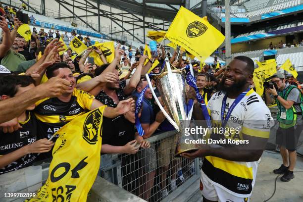 Dany Priso of La Rochelle carries the Heineken Champions Cup in front of the fans as their side celebrate after the final whistle following victory...