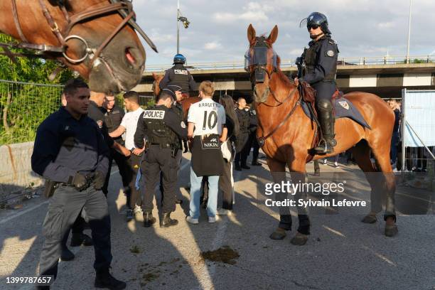 Riot police on horses check Spanish fans who gather near Stade de France prior the UEFA Champions League Final Between Liverpool and Real Madrid on...