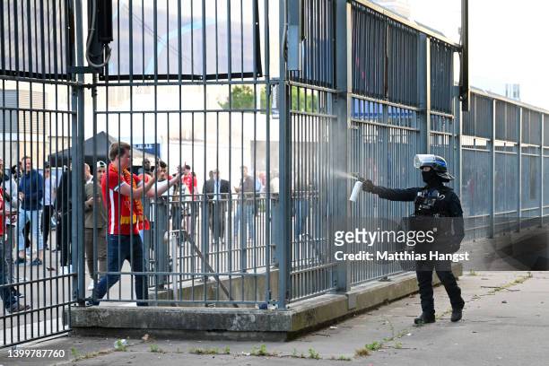 Police spray tear gas at Liverpool fans outside the stadium as fans struggle to enter prior to the UEFA Champions League final match between...