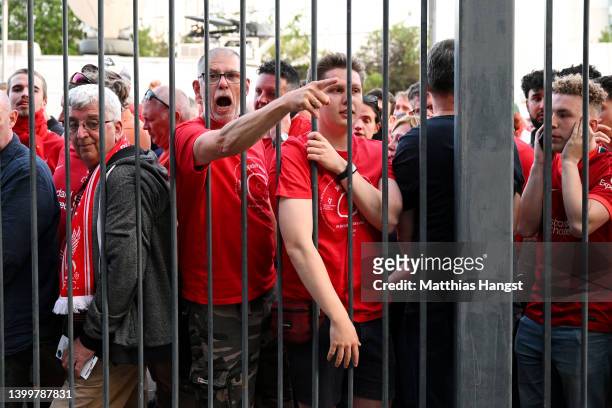 Liverpool fans react as they queue outside the stadium prior to the UEFA Champions League final match between Liverpool FC and Real Madrid at Stade...