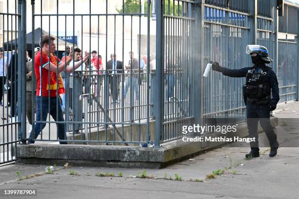 Police spray tear gas at Liverpool fans outside the stadium prior to the UEFA Champions League final match between Liverpool FC and Real Madrid at...