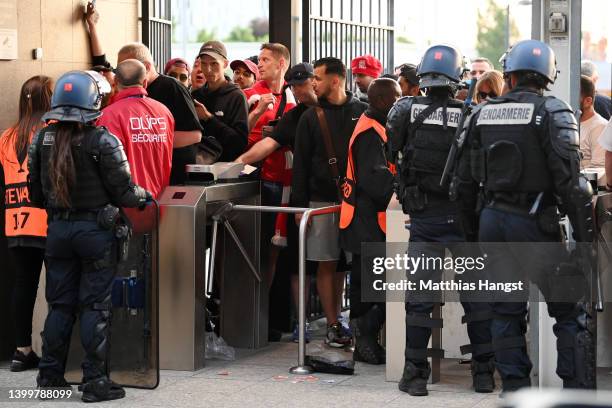 Police and stewards are seen outside the stadium as Liverpool fans queue outside the stadium prior to the UEFA Champions League final match between...