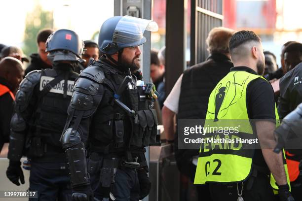 Police and stewards are seen outside the stadium as Liverpool fans queue outside the stadium prior to the UEFA Champions League final match between...