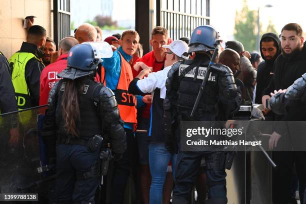 Police and stewards are seen outside the stadium as Liverpool fans queue outside the stadium prior to the UEFA Champions League final match between...