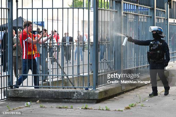 Police spray tear gas at Liverpool fans outside the stadium as they queue prior to the UEFA Champions League final match between Liverpool FC and...