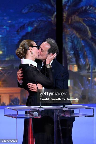 Carole Bouquet and President of the Jury Vincent Lindon kiss on stage during the closing ceremony for the 75th annual Cannes film festival at Palais...