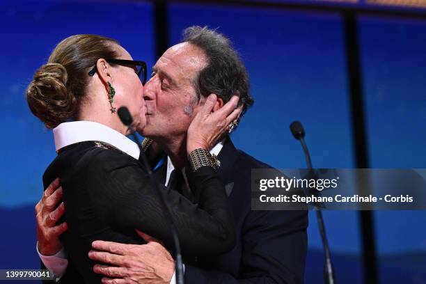 Carole Bouquet and President of the Jury Vincent Lindon kiss on stage during the closing ceremony for the 75th annual Cannes film festival at Palais...