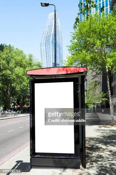 blank billboard at a bus stop - vertical billboard stock pictures, royalty-free photos & images