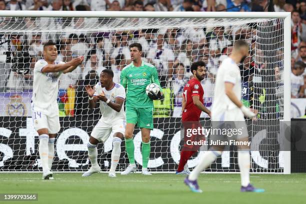 Thibaut Courtois of Real Madrid looks on whilst holding the ball during the UEFA Champions League final match between Liverpool FC and Real Madrid at...