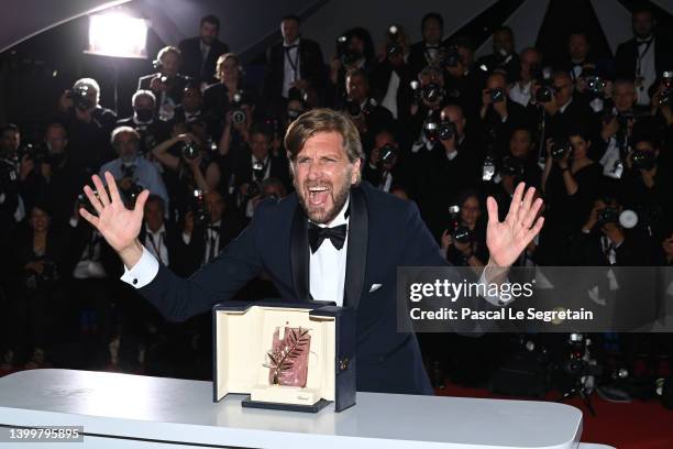 Director Ruben Ostlund poses with the Palme d'Or Award for the movie 'Triangle of Sadness' during the winner photocall during the 75th annual Cannes...