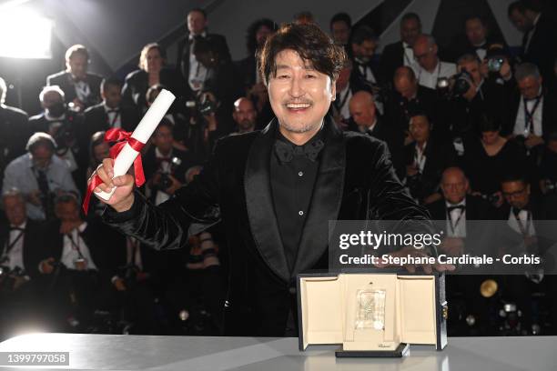 Song Kang-Ho poses with the Best Actor Palme d'Or Award for the movie 'Broker' during the winner photocall during the 75th annual Cannes film...