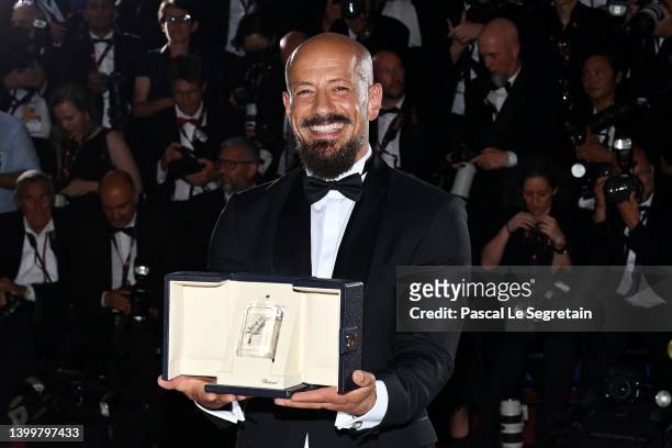 Director Tarik Saleh poses with the Best Screenplay Award for the movie 'Walad Min Al Janna' during the winner photocall during the 75th annual...