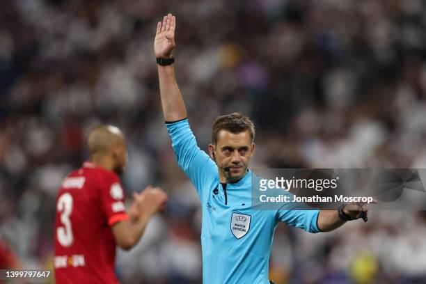 The referee Clement Turpin of France signals offside to rule out Karim Benzema of Real Madrid's goal in the first half of the UEFA Champions League...