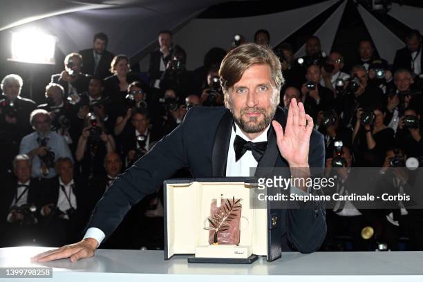 Director Ruben Ostlund poses with the Palme d'Or Award for the movie 'Triangle of Sadness' during the winner photocall during the 75th annual Cannes...