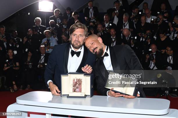 Ruben Ostlund poses with the Palme D'or Award for "Triangle of Sadness" and Tarik Saleh poses with the Best Screenplay Award for "Boy from Heaven" at...