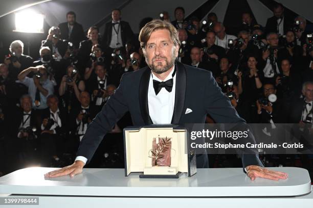 Director Ruben Ostlund poses with the Palme d'Or Award for the movie 'Triangle of Sadness' during the winner photocall during the 75th annual Cannes...