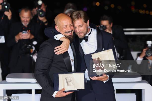 Ruben Ostlund poses with the Palme D'or Award for "Triangle of Sadness" and Tarik Saleh poses with the Best Screenplay Award for "Boy from Heaven" at...