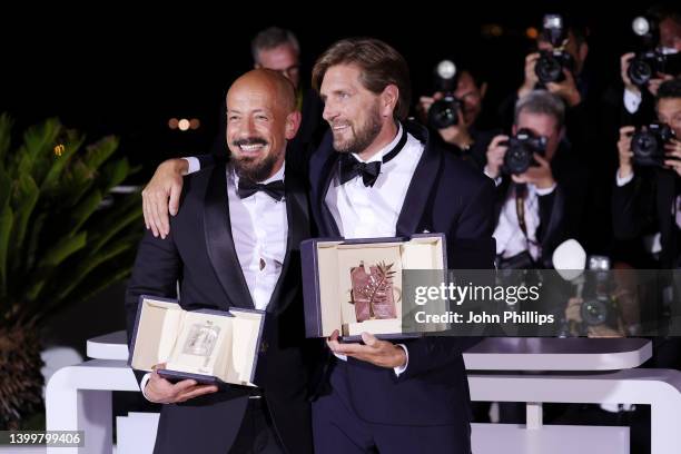 Ruben Ostlund poses with the Palme D'or Award for "Triangle of Sadness" and Tarik Saleh poses with the Best Screenplay Award for "Boy from Heaven" at...