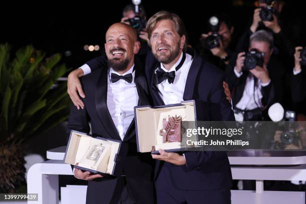 Ruben Ostlund poses with the Palme D'or Award for "Triangle of Sadness" and Tarik Saleh poses with the Best Screenplay Award for "Boy from Heaven" at...