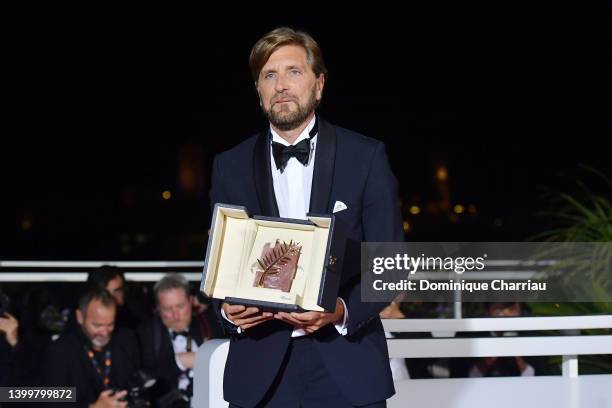 Director Ruben Ostlund poses with the Palme d'Or Award for "Triangle of Sadness" at the winner photocall during the 75th annual Cannes film festival...