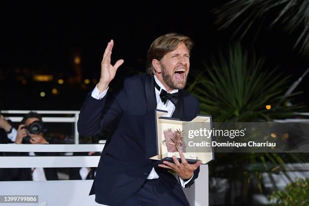 Director Ruben Ostlund poses with the Palme d'Or Award for "Triangle of Sadness" at the winner photocall during the 75th annual Cannes film festival...