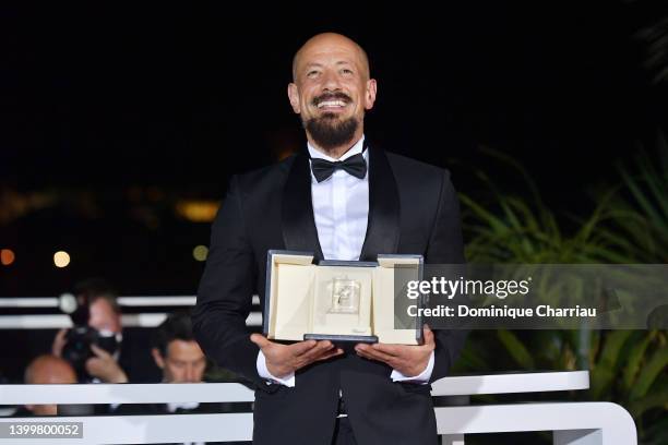 Director Tarik Saleh poses with the Best Screenplay Award for the movie 'Walad Min Al Janna' during the winner photocall during the 75th annual...