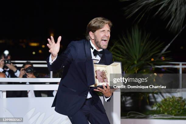 Director Ruben Ostlund poses with the Palme d'Or Award for "Triangle of Sadness" at the winner photocall during the 75th annual Cannes film festival...