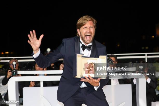 Ruben Ostlund poses with the Palme d'Or Award for "Triangle of Sadness" at the winner photocall during the winner photocall during the 75th annual...